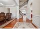 Elegant foyer with hardwood floors, staircase, and view of the dining and living spaces at 2220 Stirling Bridge Rd, Cumming, GA 30041
