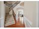 Bright foyer with hardwood floors, staircase with iron spindles, and decorative molding at 2220 Stirling Bridge Rd, Cumming, GA 30041