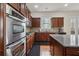 Gourmet kitchen with stainless steel oven and microwave, granite counters, and a gas range at 2220 Stirling Bridge Rd, Cumming, GA 30041