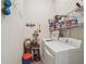 Bright laundry room featuring a white washer and dryer and plenty of shelving at 2220 Stirling Bridge Rd, Cumming, GA 30041