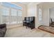 Cozy living room area with carpet flooring, piano, and a large window with lots of light at 2220 Stirling Bridge Rd, Cumming, GA 30041