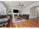 Comfortable living room with a fireplace, hardwood floors, and a ceiling fan at 2220 Stirling Bridge Rd, Cumming, GA 30041