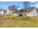 The home's backyard features a large lawn, patio, and gray siding with complementing trim at 4419 White Rd, Douglasville, GA 30135