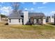 The home's backyard features a lawn, patio, and exterior with gray siding and complementing trim at 4419 White Rd, Douglasville, GA 30135