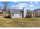 Backyard view showcasing the home's exterior, patio area, and well-maintained lawn at 4419 White Rd, Douglasville, GA 30135