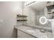 Bright bathroom featuring granite countertops, decor shelving and a vanity with sleek fixtures at 4419 White Rd, Douglasville, GA 30135