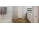 Well-lit bathroom with a granite countertop vanity, tub, and decorative shelving at 4419 White Rd, Douglasville, GA 30135