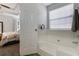 Bright, clean bathroom with a tub and shower combination with neutral tile surround at 4419 White Rd, Douglasville, GA 30135