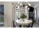 Cozy dining area featuring a modern light fixture, fireplace and adjacent access to the outdoors at 4419 White Rd, Douglasville, GA 30135