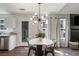 Modern dining area with stylish lighting, table, and seamless indoor-outdoor flow at 4419 White Rd, Douglasville, GA 30135