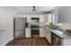 Well-lit kitchen equipped with stainless steel appliances, granite countertops, and ample cabinet space at 4419 White Rd, Douglasville, GA 30135