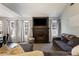 Comfortable living room featuring a fireplace, large TV, and neutral décor at 4419 White Rd, Douglasville, GA 30135