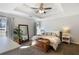 Spacious bedroom featuring a tray ceiling, comfortable furnishings and neutral decor at 4419 White Rd, Douglasville, GA 30135