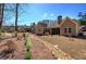 Beautiful backyard features a rock-lined dry creek bed and lush landscaping at 115 Dorys Way, Dallas, GA 30157