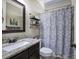 Well-maintained bathroom with granite countertops, decorative mirror and patterned shower curtain at 115 Dorys Way, Dallas, GA 30157