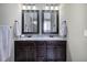 Bathroom featuring a granite countertop double vanity, framed mirrors, and ample lighting fixtures at 115 Dorys Way, Dallas, GA 30157