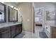 A well-lit double sink bathroom that leads to the Primary bedroom with a bathtub at 115 Dorys Way, Dallas, GA 30157