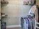 Organized walk-in closet providing ample storage space with its multiple shelves and hanging racks at 115 Dorys Way, Dallas, GA 30157