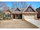 Charming stone and siding home featuring a well-manicured lawn and a two-car garage at 115 Dorys Way, Dallas, GA 30157