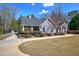 Charming exterior with gray siding, covered porch, manicured lawn and decorative shrubs at 115 Dorys Way, Dallas, GA 30157