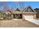 Charming stone and siding home featuring a well-manicured lawn and a two-car garage at 115 Dorys Way, Dallas, GA 30157