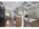 Open kitchen features granite countertops, stainless appliances, hardwood floors, and barstool seating at 115 Dorys Way, Dallas, GA 30157