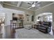 Bright living room with hardwood floors, coffered ceiling, and seamless flow to other rooms at 115 Dorys Way, Dallas, GA 30157