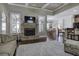 Inviting living room with a stone fireplace, hardwood floors, and coffered ceilings at 115 Dorys Way, Dallas, GA 30157