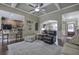 Open-concept living room features coffered ceilings, hardwood floors, and seamless flow to the kitchen at 115 Dorys Way, Dallas, GA 30157