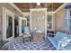 Covered porch with ceiling fan, comfortable seating, and views of the backyard at 115 Dorys Way, Dallas, GA 30157