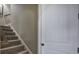 Carpeted staircase with white risers leads to the upper level of this lovely home at 115 Dorys Way, Dallas, GA 30157
