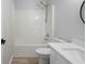 This bathroom features a shower and tub combo, toilet, and vanity with white cabinets at 1196 Yellow River Dr, Lawrenceville, GA 30043
