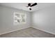 This bedroom offers neutral walls, carpet flooring, a window, and modern ceiling fan at 1196 Yellow River Dr, Lawrenceville, GA 30043