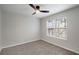 This bedroom offers neutral walls, carpet flooring, a window, and modern ceiling fan at 1196 Yellow River Dr, Lawrenceville, GA 30043