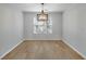 Bright dining room features hardwood floors, modern light fixture and a large window at 1196 Yellow River Dr, Lawrenceville, GA 30043