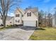 Two-story home featuring an attached garage, driveway, and manicured lawn at 1196 Yellow River Dr, Lawrenceville, GA 30043