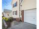 Close-up of a well-maintained home featuring a two-car garage and landscaped yard at 1196 Yellow River Dr, Lawrenceville, GA 30043