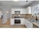 Kitchen features a stainless oven and microwave, stone countertop, and stylish backsplash at 1196 Yellow River Dr, Lawrenceville, GA 30043