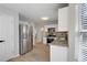 Bright kitchen features stainless steel appliances, granite counters and a view to the living area at 1196 Yellow River Dr, Lawrenceville, GA 30043