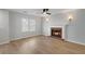Cozy living room featuring a brick fireplace, hardwood floors, and modern light fixtures at 1196 Yellow River Dr, Lawrenceville, GA 30043