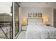 Bright bedroom with a large window offering city views, a comfortable bed, and modern decor at 1820 Peachtree Nw St # 303, Atlanta, GA 30309