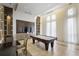 A well lit game room featuring a pool table, television, and dark wood trim at 1820 Peachtree Nw St # 303, Atlanta, GA 30309