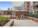 This outdoor patio includes multiple potted plants, red brick construction, and stone pavers at 1820 Peachtree Nw St # 303, Atlanta, GA 30309