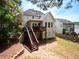 Home backyard with wooden deck and stairs, set in a serene, lush environment at 507 Autumn Walk, Canton, GA 30114