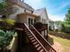 Backyard with a wooden deck, stairs, lawn, and privacy landscaping at 507 Autumn Walk, Canton, GA 30114
