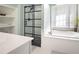 Bright bathroom with a soaking tub and a black-framed glass shower at 507 Autumn Walk, Canton, GA 30114