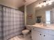 Functional bathroom featuring a shower with a striped curtain, toilet, and vanity with a large mirror at 507 Autumn Walk, Canton, GA 30114