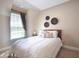 Bright bedroom featuring a white bedspread, decorative wall art, and a window with natural light at 507 Autumn Walk, Canton, GA 30114