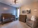 Charming Bedroom featuring a crib, changing table, glider chair, and a decorative ceiling light at 507 Autumn Walk, Canton, GA 30114