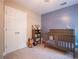 Well-organized Bedroom with a crib, a toy shelf, and ample storage in a two-door closet at 507 Autumn Walk, Canton, GA 30114